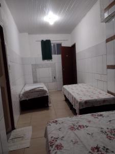 um quarto com duas camas e um espelho num quarto em Pousada Trilha do Pelo em Salvador