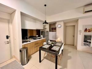 a kitchen with a table and chairs in a room at Radia Residence Bukit Jelutong, Shah Alam in Shah Alam