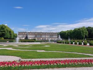 a palace with a park with flowers and a fountain at Pilzhof in Schleching