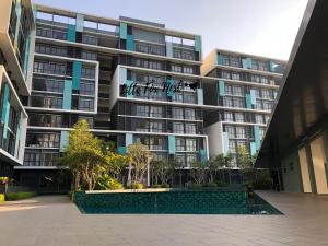 an apartment building with a courtyard in front of it at Little Fox Nest at KLIA Sepang and Gamuda SplashMania in Sepang