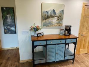 a desk in a room with a coffee maker on it at Blue Sky Cabin - Built in 2023 this 3 bed 2,5 bath home has gorgeous views in Jefferson