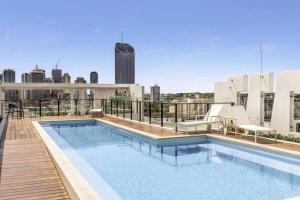 a swimming pool on the roof of a building at South Bank Central 1 bedroom apartment with Parking in Brisbane