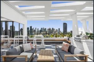 a rooftop patio with furniture and a view of the city at South Bank Central 1 bedroom apartment with Parking in Brisbane