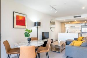 a living room with a table and a couch at South Bank Central 1 bedroom apartment with Parking in Brisbane