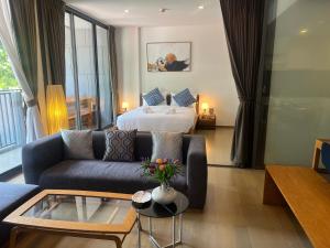 a living room with a couch and a bed at Deluna 23degree by The valley khao yai in Pak Chong +34 photos