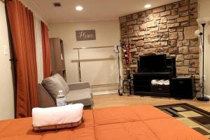 a living room with a stone wall at Modern Comfort Stays in Alexandria