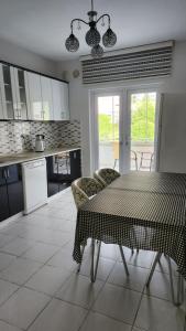 a kitchen with a table and chairs in a kitchen at Arya home 18 in Trabzon