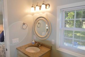 a bathroom with a sink and a mirror at Carraig Dale Cottage in Fish Creek +37 photos