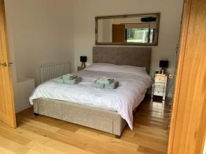 a bedroom with a bed with two pillows on it at THE BOATHOUSE. The gateway to the Jurassic Coast in Hamworthy