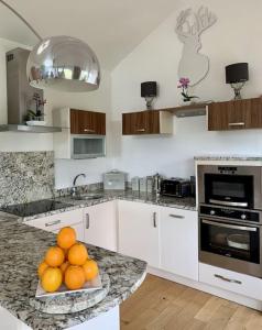 a kitchen with a bowl of oranges on a counter at THE BOATHOUSE. The gateway to the Jurassic Coast in Hamworthy