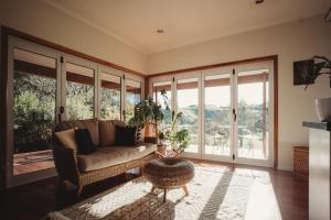 a living room with a couch and a table at Paradise Valley Lodge in Rotorua