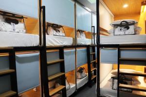 a group of bunk beds in a room at AMANGO HOSTEL in Ho Chi Minh City