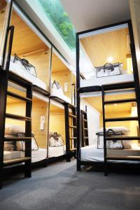 a room with four bunk beds in a building at AMANGO HOSTEL in Ho Chi Minh City