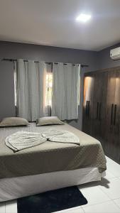 Ένα ή περισσότερα κρεβάτια σε δωμάτιο στο Tangará da Serra