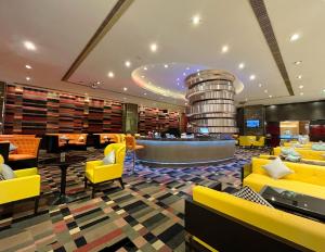 上海的住宿－上海大寧福朋喜來登酒店，酒店大堂设有黄色椅子和葡萄酒桶