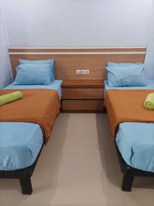 Ένα ή περισσότερα κρεβάτια σε δωμάτιο στο Merendeng Hostel Kuta