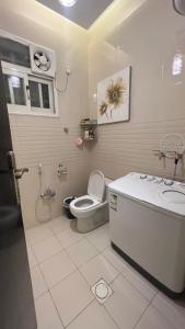 a bathroom with a toilet and a sink at ليلك lilac in Abha