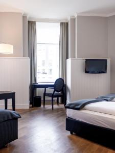 Cama ou camas em um quarto em Hotel Victoria