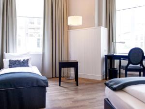 Cama ou camas em um quarto em Hotel Victoria