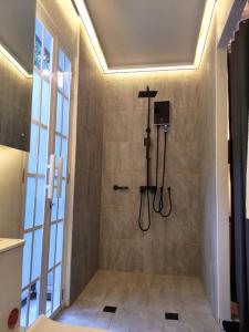 a shower stall in a bathroom with a shower at Puerto Galera Home in Balatero