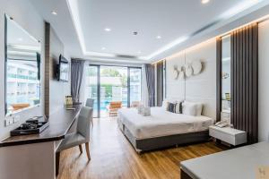 Cette chambre comprend un lit et un bureau. dans l'établissement Chaolao Cabana Resort, à Chao Lao Beach