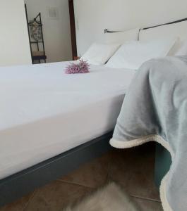 a large white bed with a blanket on it at FBM Anagenessis - Ευ Ζην in Edessa