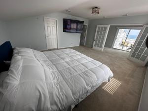 a bedroom with a large bed and a large window at Beach House in heart of NYC in Arverne