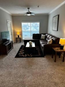 a living room with a leather couch and a table at Extravagant 2 BR/2 BA Apartment in Savannah