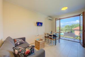 a living room with a couch and a table at Cottage Del Lago - Happy Rentals in Laveno