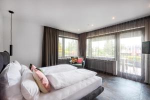 a living room with a white couch and windows at PRIMERA am See in Gaienhofen