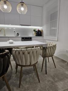 a kitchen with a table and two chairs at Apartman City Pearl in Posušje