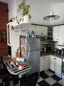 a kitchen with a refrigerator and a table with food at La casa de Lily in Alta Gracia