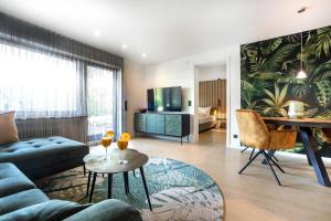a living room with a couch and a table at PRIMERA am See in Gaienhofen