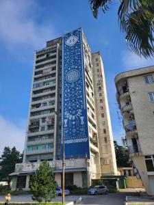 a building with a blue mural on the side of it at Green Palma in Kutaisi