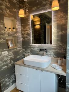 a bathroom with a sink and a mirror at Loft prestigioso nel centro di Sanremo in Sanremo