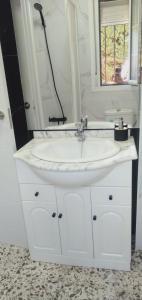 a bathroom with a white sink and a mirror at Apartamentos Camping El Palmar in El Palmar