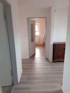an empty room with a hallway with a wooden floor at Ferienwohnung - Mitten in Lauf - 2 Zimmer, große Küche in Lauf an der Pegnitz +1 photo