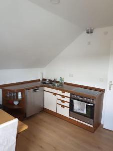 a kitchen with a sink and a stove at Ferienwohnung - Mitten in Lauf - 2 Zimmer, große Küche in Lauf an der Pegnitz