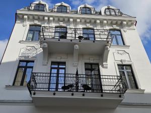 a white building with a balcony on it at Tomis’ Dreams in Constanţa