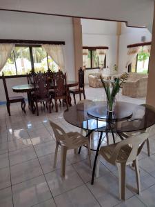 a living room with tables and chairs and a couch at Capul Beach Resort in Capul