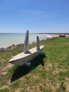 a bench sitting on the grass near the beach at Apartament vacanta in Mangalia