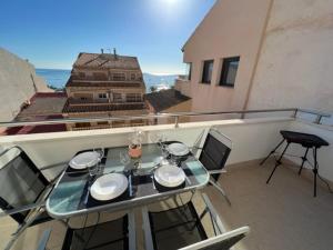 a table and chairs on a balcony with a view at Sublime appartement vue Mer avec Piscine in El Campello