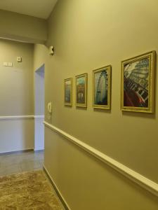 a hallway with four pictures on a wall at البيت بيتك in King Abdullah Economic City