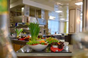 a kitchen with bowls of vegetables on a counter at Blue Pearl Hotel - Ultra All - Inclusive in Sunny Beach