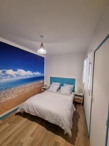 una camera da letto con un letto dipinto sull'oceano di Bienvenue à la plage ! ad Argelès-sur-Mer