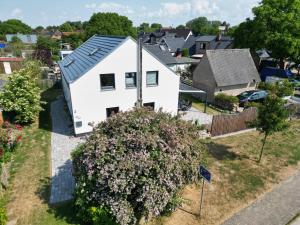 an aerial view of a white house with a large bush at # Urlaubsreif in Zierow