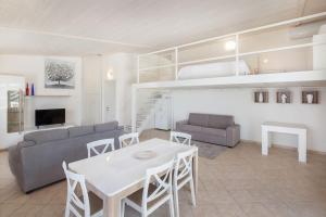 a living room with a table and a couch and a loft at Villa Roby-Loft a Torri del Benaco in Torri del Benaco