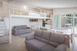 a living room with a couch and a loft bed at Villa Roby-Loft a Torri del Benaco in Torri del Benaco +15 photos
