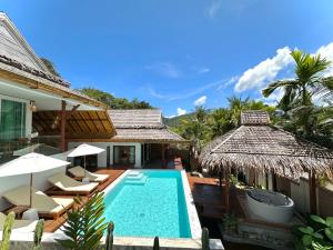 a villa with a swimming pool and a resort at Baan Phuvara Retreat - Romantic Jacuzzi Mountain View Villas in Ao Nang Beach