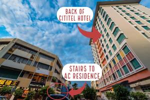 two buildings with signs that say back of a critical hotel at AC Residence - Behind Cititel Hotel in Kota Kinabalu